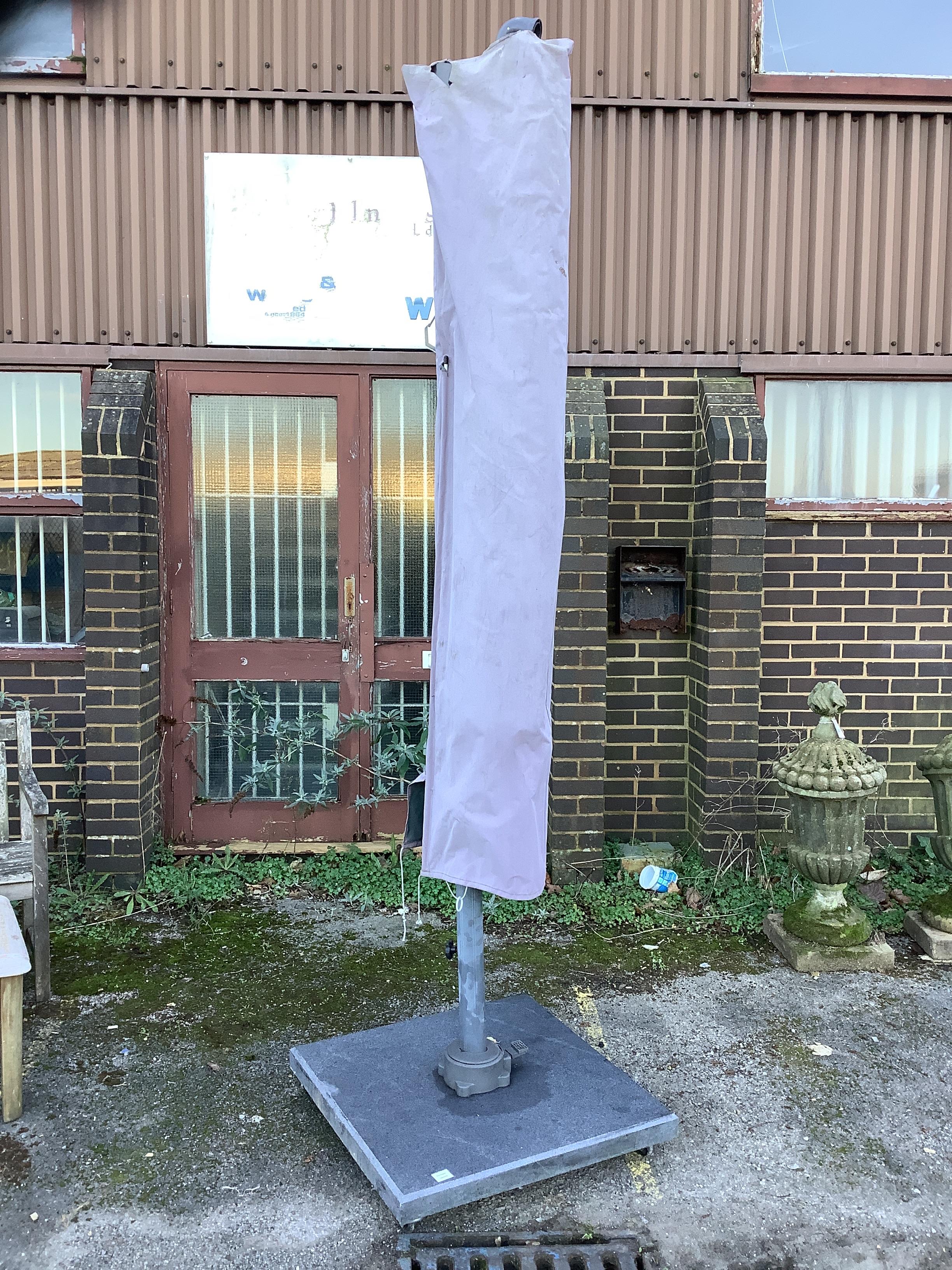A large garden crank parasol and base